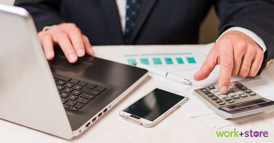 A closeup image of a businessman calculating company finances