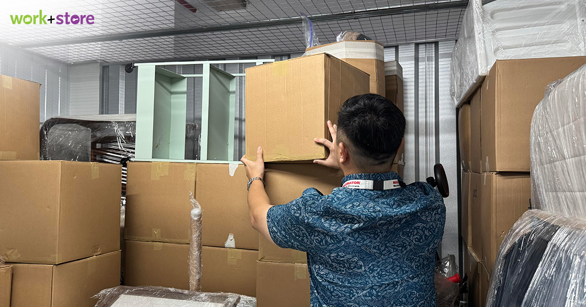 man arranging boxes in his rented self storage unit