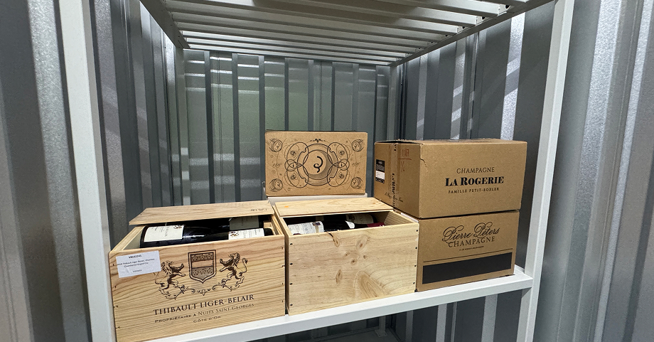 Premium wine collection stored in cases within a storage unit.