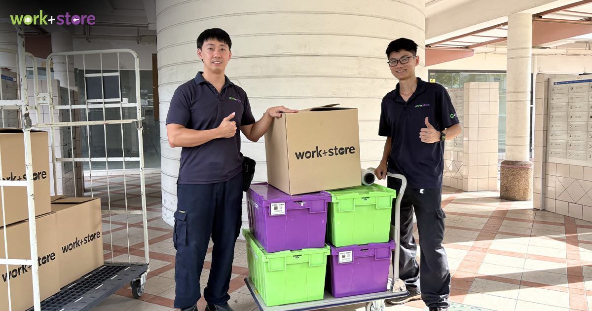 Two movers with boxes and crates for storage services.