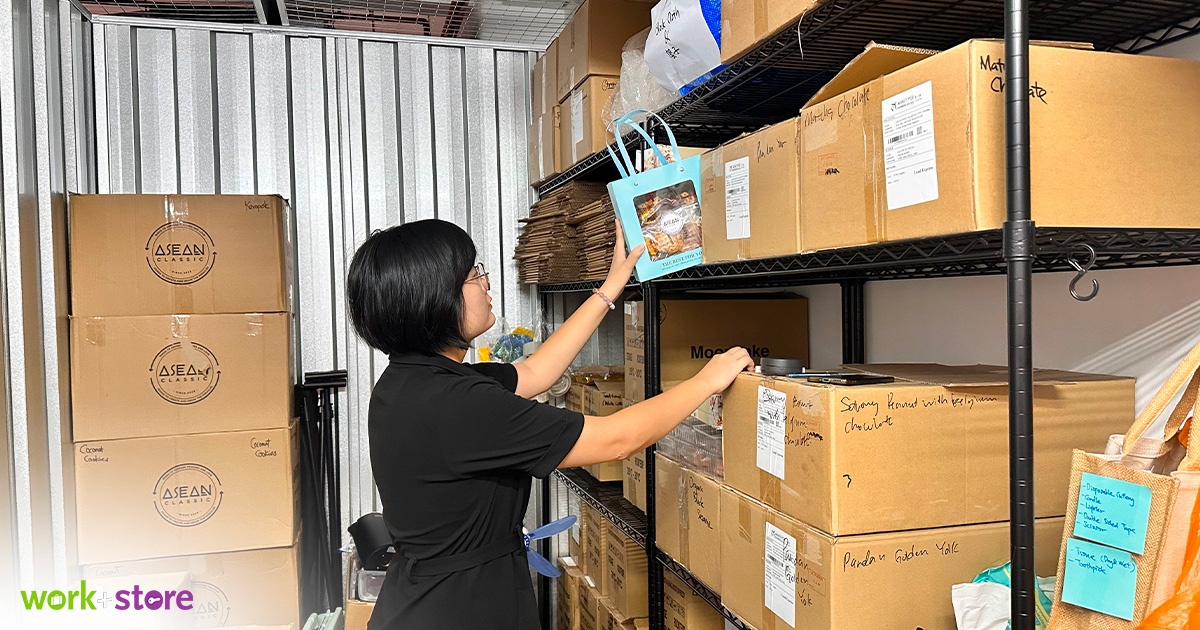 Person organizing boxes in storage area.